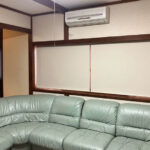 ロールスクリーンとソファのある部屋